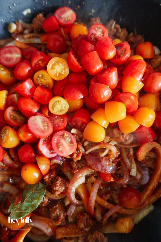 Veg base for baked cod with chorizo with tomatoes, peppers, onion and lemon.
