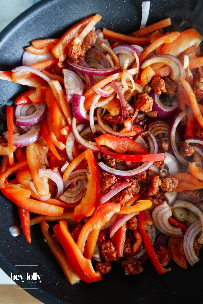 Veg base for baked cod with chorizo with tomatoes, peppers, onion and lemon.