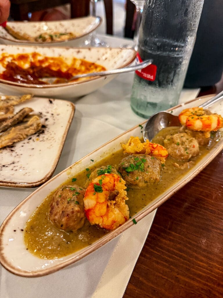 Spanish tapas plates shared at the table, showing how travel influences cooking by inspiring social dining rituals and the joy of lingering meals.