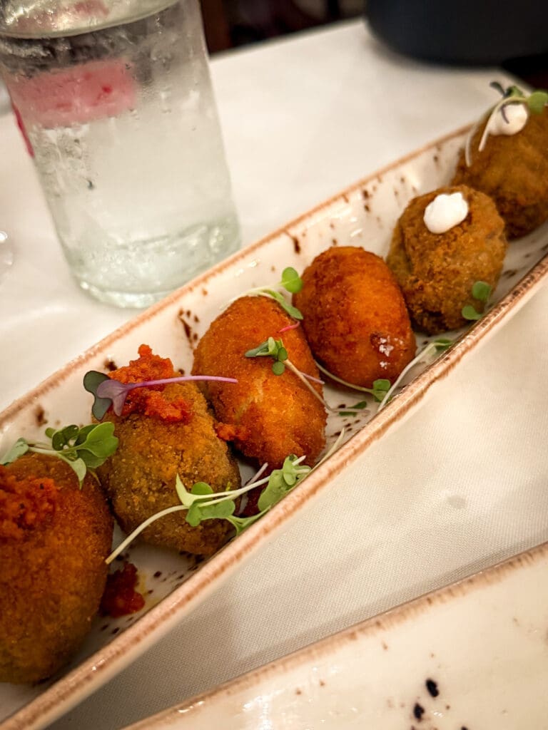 Spanish tapas plates shared at the table, showing how travel influences cooking by inspiring social dining rituals and the joy of lingering meals.