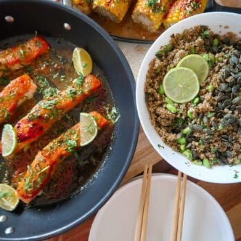 Glazed salmon fillet atop garlic-ginger quinoa pilaf with miso-glazed corn and fresh herbs.