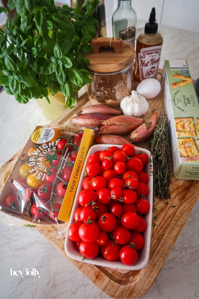 Overhead shot of ingredients for a golden shallot and tomato tart