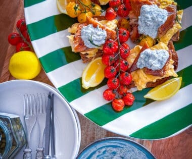 Scandi-style breakfast with eggs, mackerel, tomatoes, and crème fraîche on sourdough.