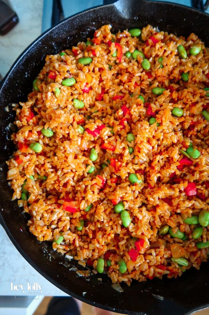 Stir-frying cold brown rice over high heat for Korean-style fried rice texture.