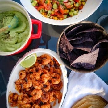 Seared prawns with avocado cream and summer salsa on table to share