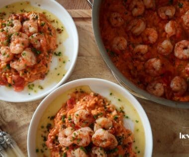Creamy king prawn tomato risotto served with garlic lemon butter and chives