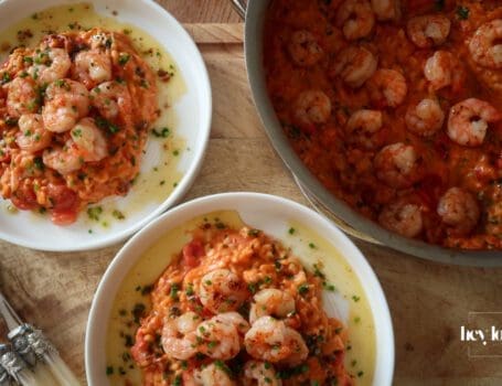 Creamy king prawn tomato risotto served with garlic lemon butter and chives