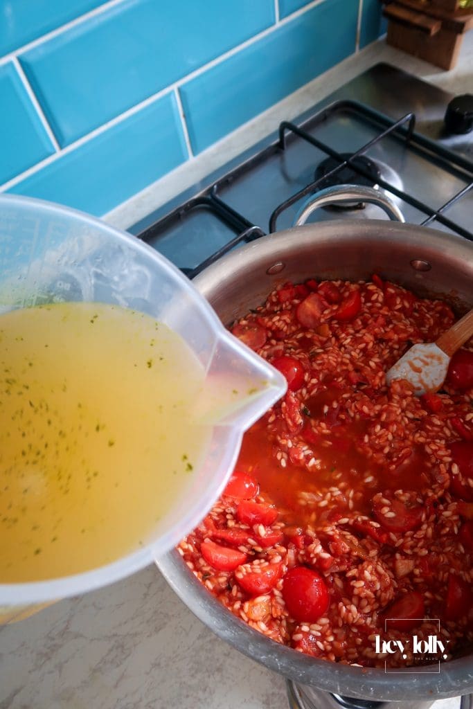 Tinned and fresh tomatoes simmering into risotto rice for king prawn tomato risotto waiting for stock to be added