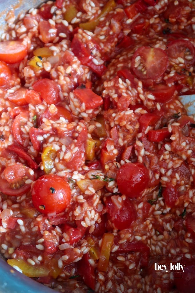 Tinned and fresh tomatoes simmering into risotto rice for king prawn tomato risotto