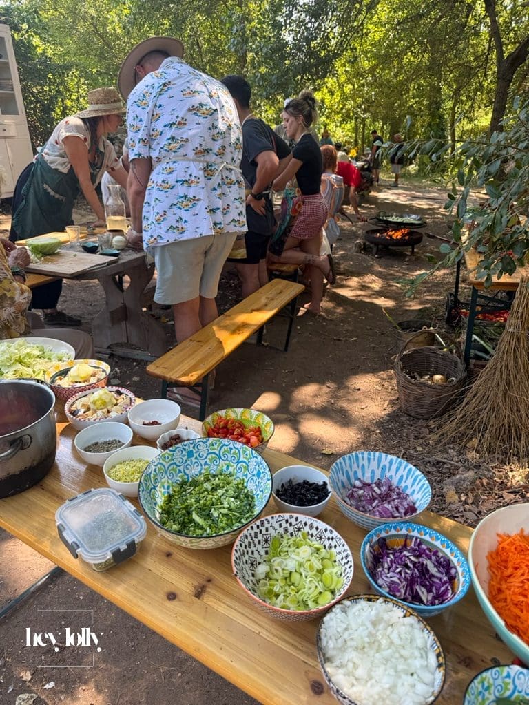 Guests cooking together outdoors during a garden-to-table class in Syracuse Sicily.