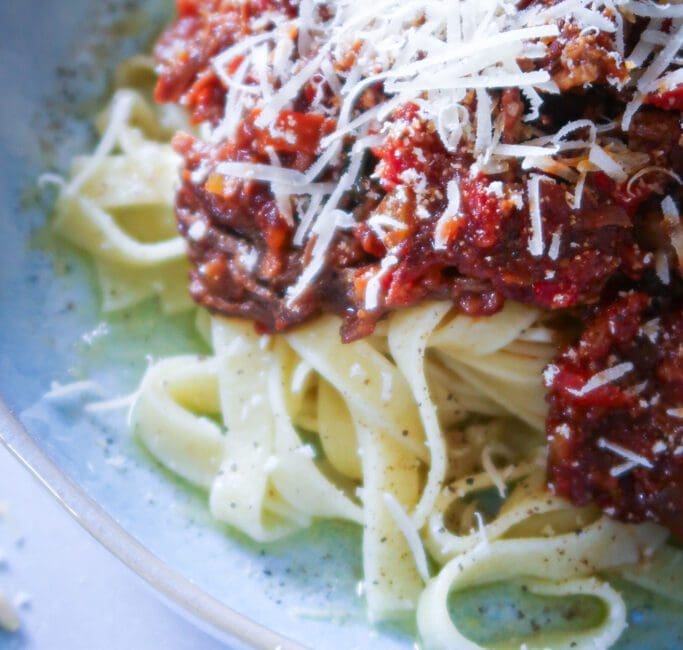 plated rich beef ragu with tagliatelle and freshly shaved parmesan