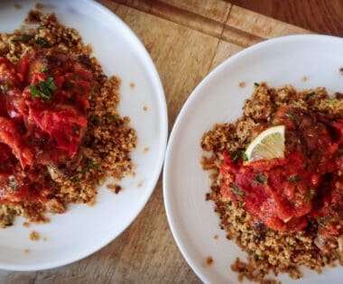 uicy Za’atar Chicken Thighs with golden skin and roasted tomato anchovy topping”
