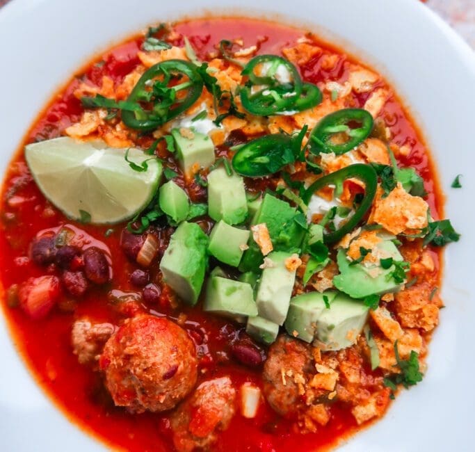 Close-up of smoky Cowboy Taco Soup showing black beans, sweetcorn and charred peppers