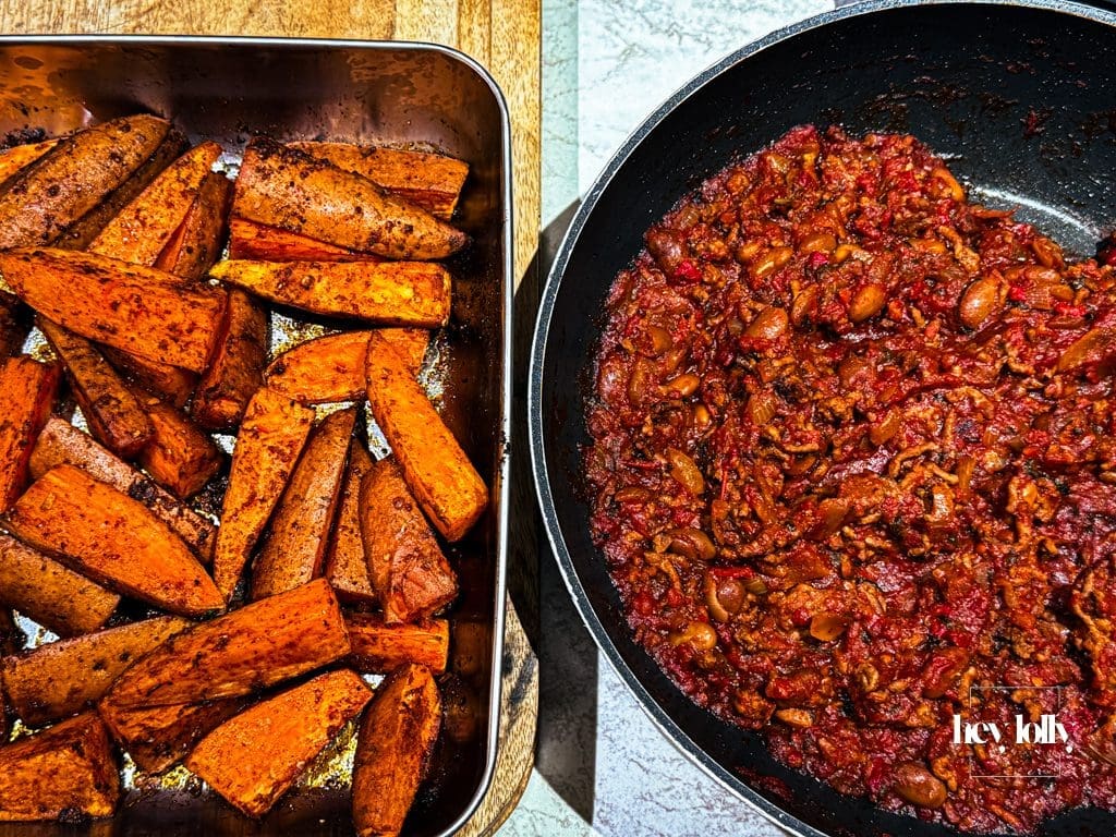 Fries piled on a tray; Sloppy Joe spooned over in generous layers.