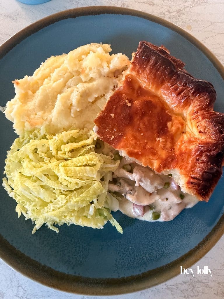 Slice of chicken, pea and pancetta pie showing creamy Dijon filling