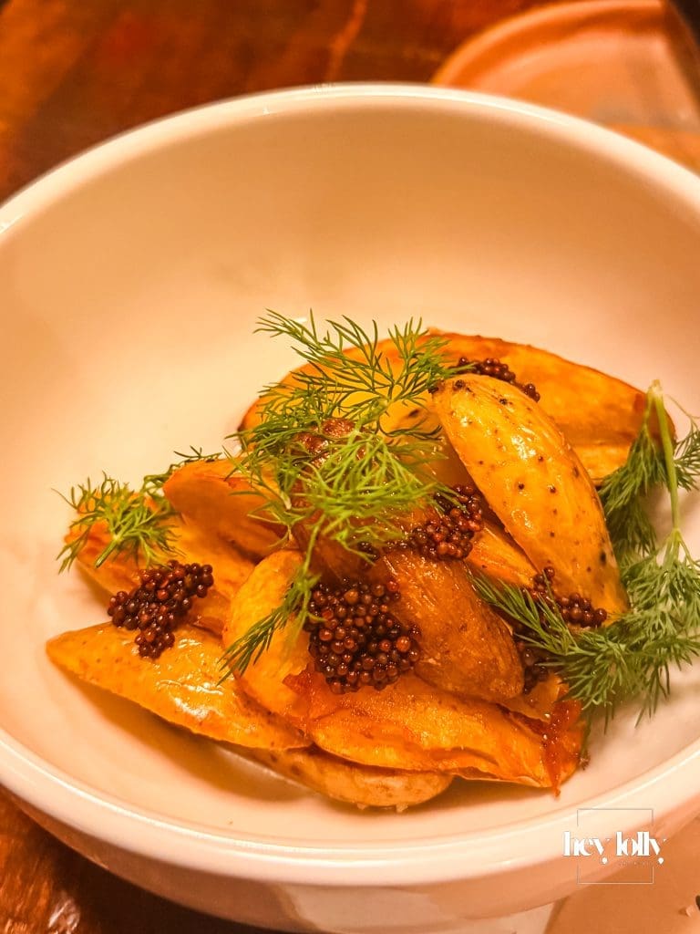 Ratte potatoes with dill, mustard seeds and buttermilk dressing in a white bowl at Piccalilli Nottingham