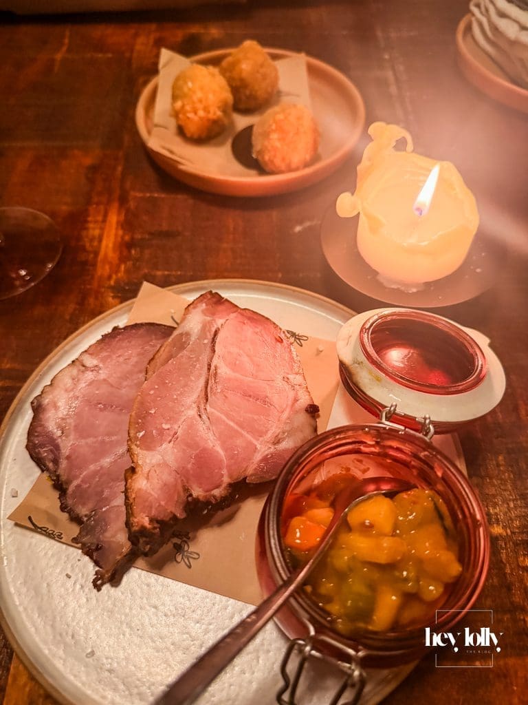 Treacle baked ham with house piccalilli on a candlelit wooden table – Piccalilli Nottingham review