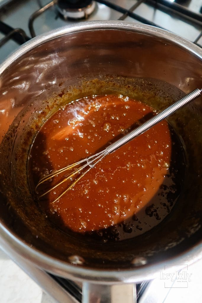 Butter, soft brown sugar and double cream set out for burnt-butter caramel, saucepan nearby.