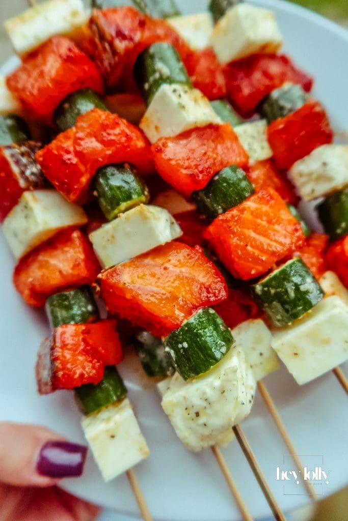 Close-up of even spacing on skewers so salmon halloumi and courgette cook at the same pace.