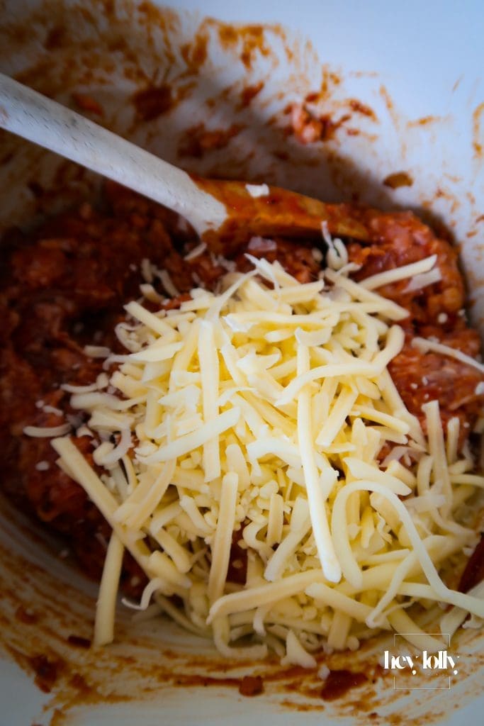Close-up of seasoned sausage meat with cheddar cheese.