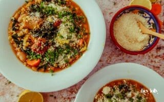 oven on world off pearl barley stew overhead shot in white bowls with grated parmesan and lemon zest