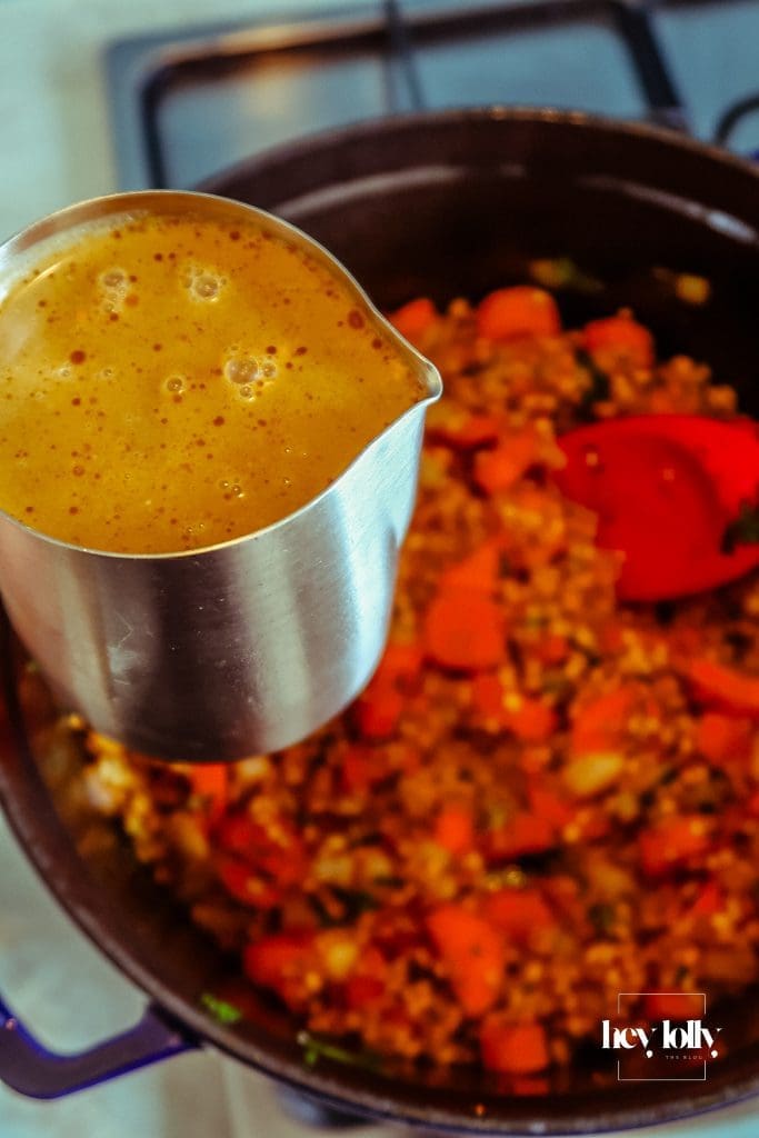 Chunky carrot batons and pearl barley stirred into the pot before stock is added for the stew