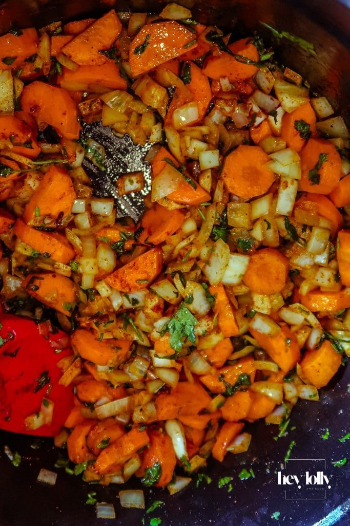 Chunky carrot batons and pearl barley stirred into the pot before stock is added for the stew