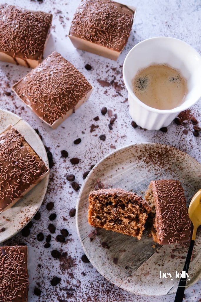Slice of pecan and coffee cake served with a mug of coffee, styled as a cosy afternoon treat.
