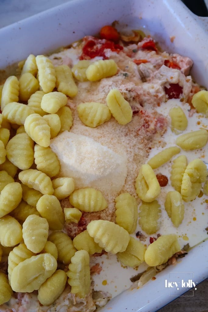 Gnocchi stirred into the creamy sauce for salmon and fennel gnocchi bake before the final bake

Parmesan topping: