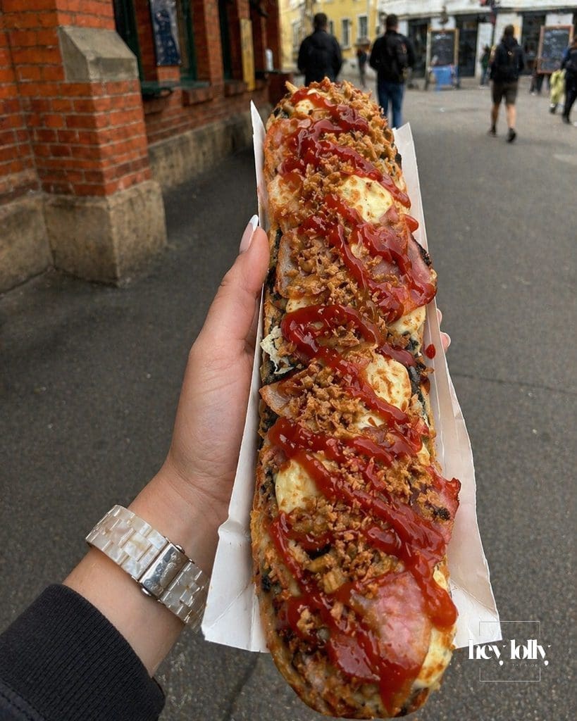 Close up of zapiekanki in Krakow with cheese, sauce and crispy onions