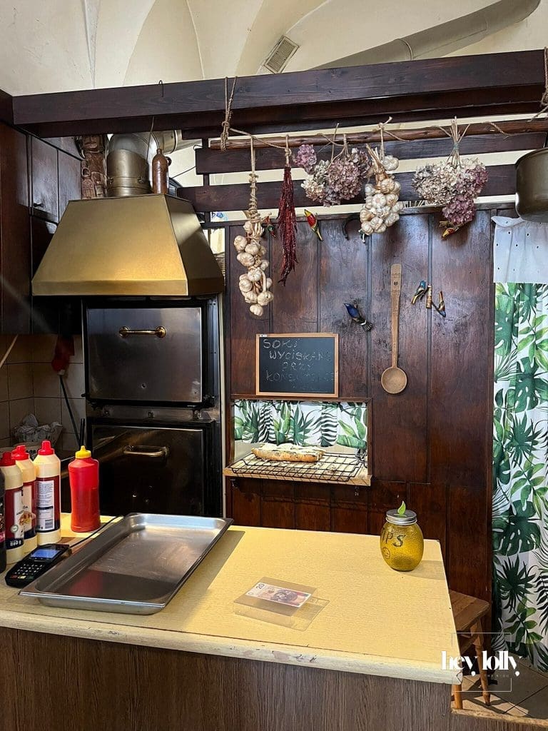Traditional zapiekanki counter in Krakow with oven and menu