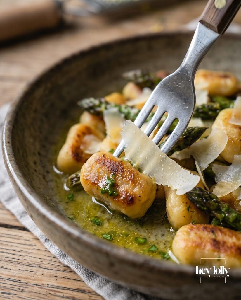 Plated lemon tarragon gnocchi with charred asparagus and parmesan