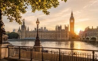 Golden hour view across the River Thames towards Big Ben and the Houses of Parliament for first-time visitors planning the best London tours.