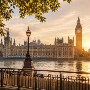 Golden hour view across the River Thames towards Big Ben and the Houses of Parliament for first-time visitors planning the best London tours.