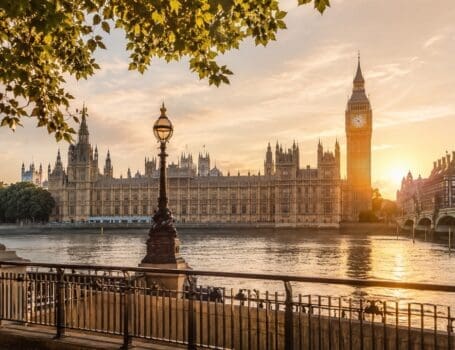 Golden hour view across the River Thames towards Big Ben and the Houses of Parliament for first-time visitors planning the best London tours.