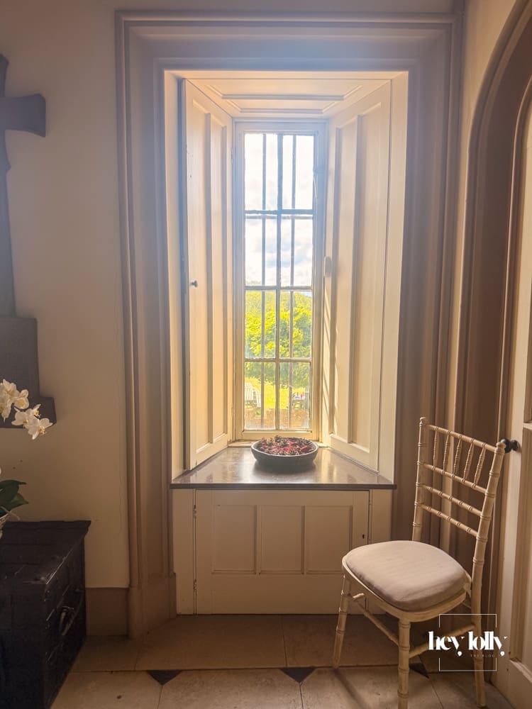 Light-filled interior room at Belvoir Castle with arched windows and historic details