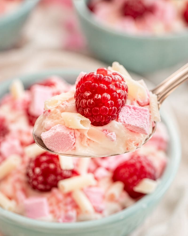 Raspberry whip topped with raspberries, crushed meringue and white chocolate