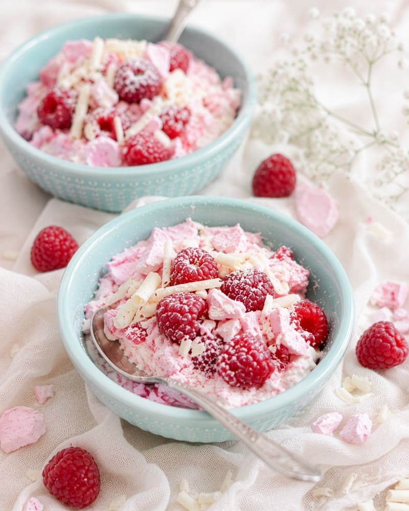 Lovestruck raspberry whip with white chocolate curls, raspberries and crushed pink meringue